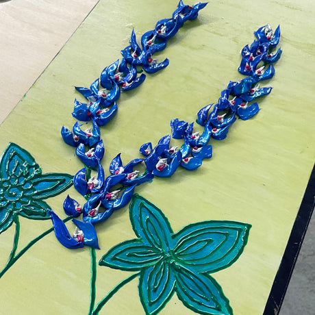 bluebonnets with green leaves on yellow background textured floral painting by Bala Thiagarajan, hand-piped acrylic on wood panel with iridescent sculptural detail