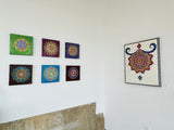 Framed 24x30 original New Bloom Mandala 3D textured painting by Bala Thiagarajan, featuring an off-center henna-style floral pattern, dichroic glass center, and iridescent acrylic relief in a gallery wall