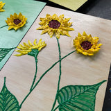 yellow sunflowers with green leaves on brown background textured floral painting by Bala Thiagarajan, hand-piped acrylic on wood panel with iridescent sculptural detail